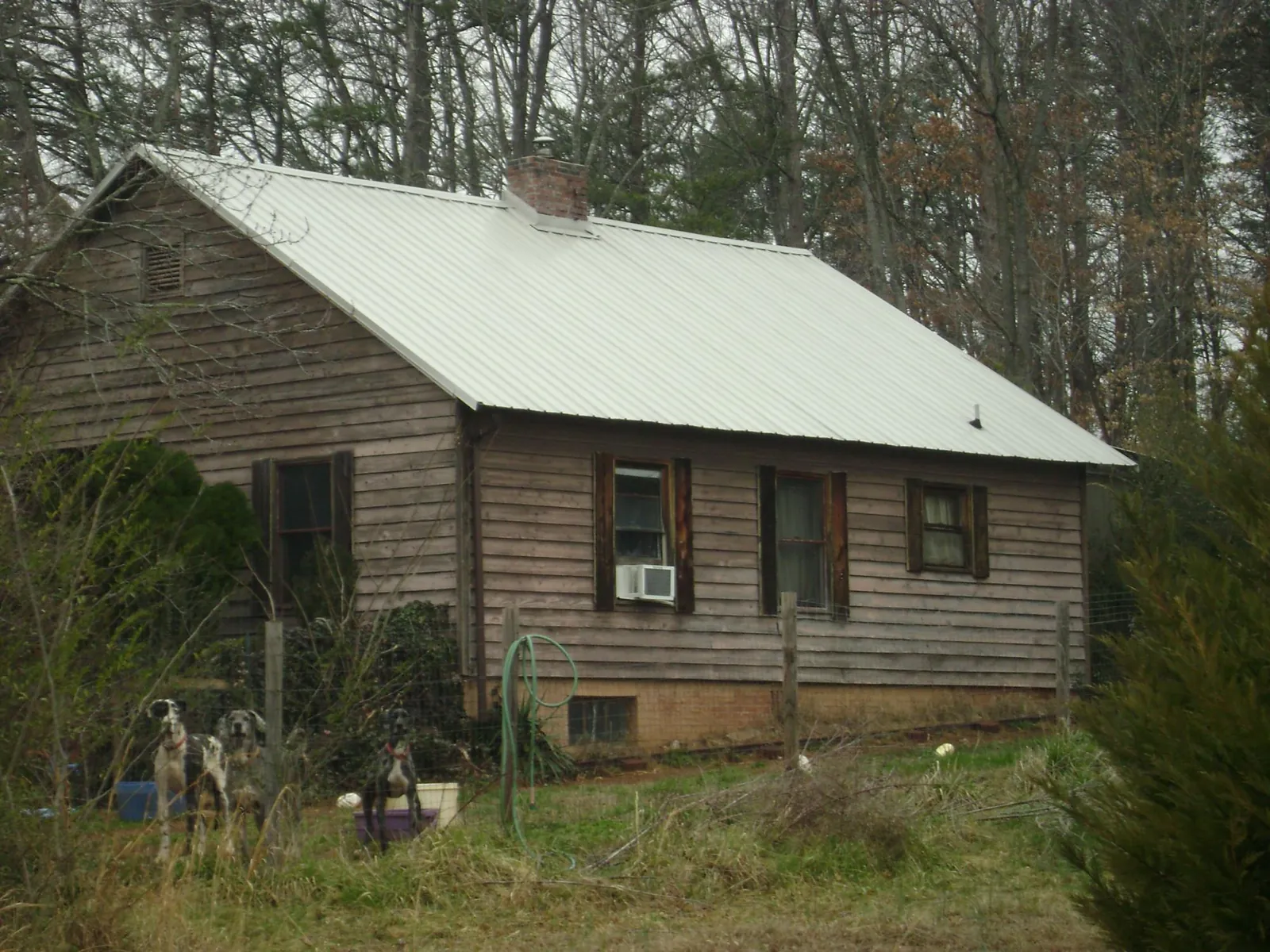 White metal roof on an old wood sided farmhouse, from a Metal Roof Installation job in Stockton
